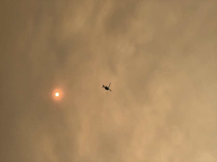 Smoke from the Bobcat Fires covers the sky and makes the sun glow orange. 