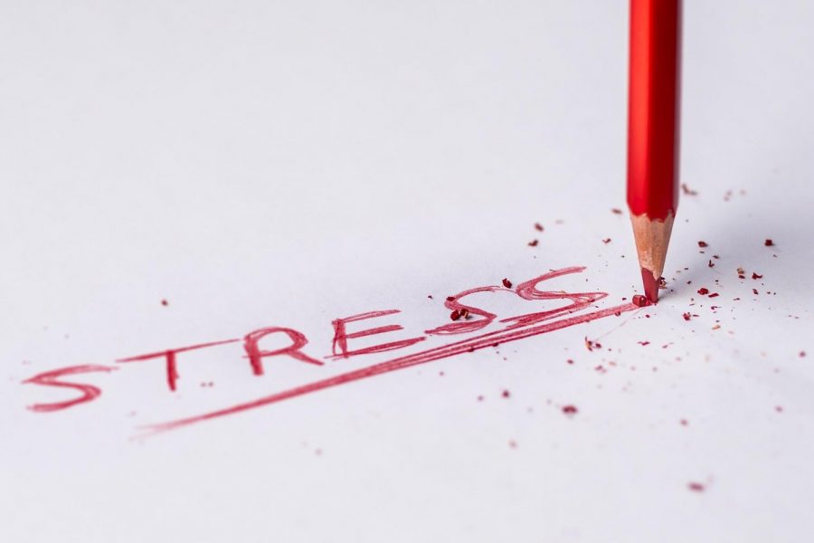 Stress written in red pencil. Image by Pedro Figueras from Pixabay.
