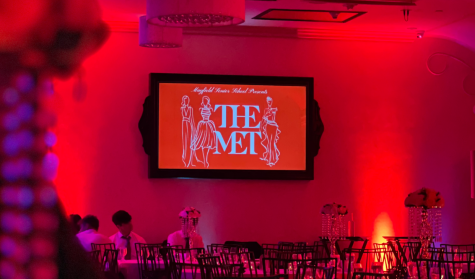 The Mayfield Prom venue, Noor, lit with red lights and adorned with a screen that features “The Met” sign.