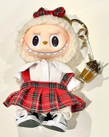 Trending Labubu smiling in an off-white background wearing a Mayfield-themed uniform. 

