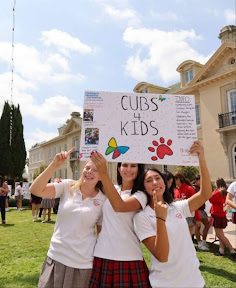 Cubs for Kids Co-heads Harper Link and Charlotte Norton, along with their friend Alexandra Trujillo ‘28 excited for the fair and showing off their well crafted club poster. 

