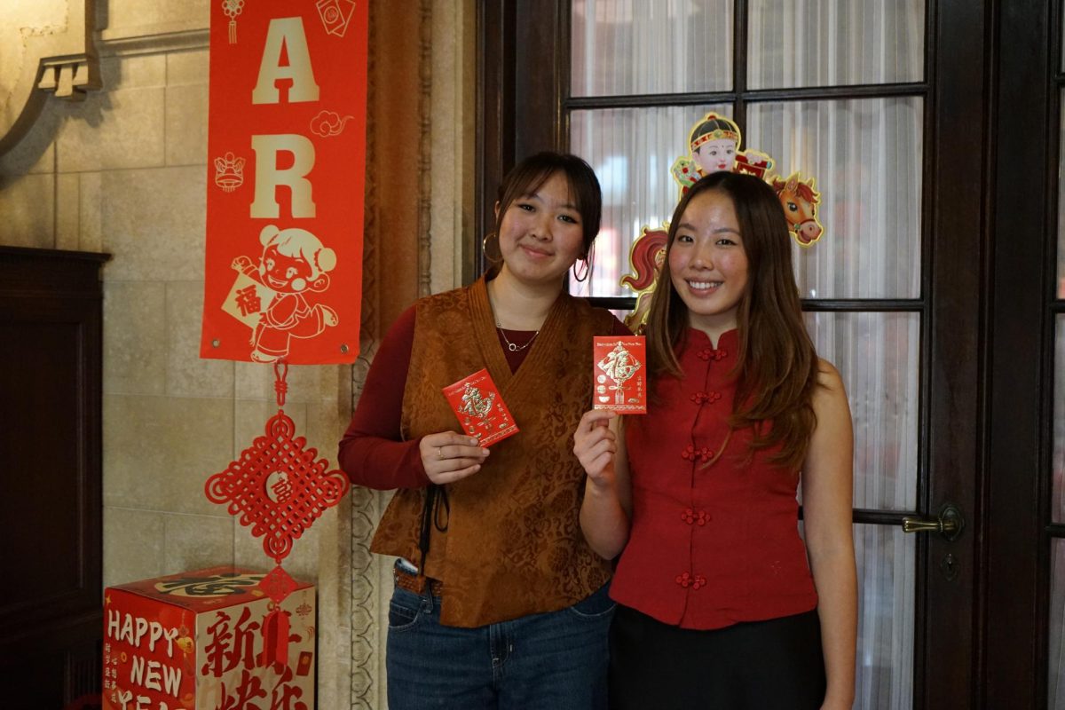 Annie Li ‘26 and Zoe Chiu ‘26 stand in the front of the living room, decorated for Chinese New Year. Credit: Mayfield Crier
