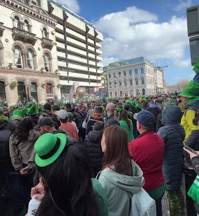 Photo taken in town on St. Patrick's day while waiting for the infamous parade. People wait for hours and fly in from all over the world  in hopes of getting a glimpse at the intricate floats, bands, dancers, performers, music, and more. 