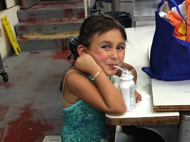 Caption: Guiliana at age 5, backstage in costume before performing in her first show, Xanadu.